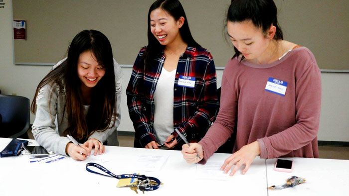 Three members filling out worksheets