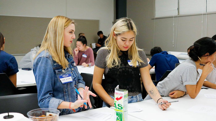 Two members filling out worksheets