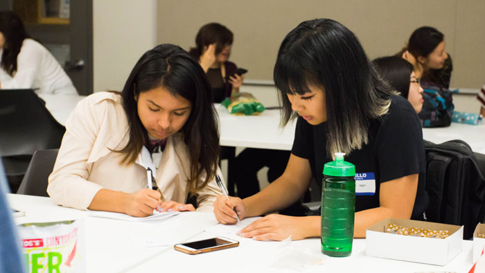 Two members filling out worksheets